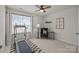 A versatile bedroom with a treadmill, ceiling fan, and natural light offering a flexible living space at 15122 Lake Ridge Rd, Charlotte, NC 28278