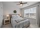 Comfortable bedroom with a ceiling fan, large window, and stylish décor creating a cozy and inviting atmosphere at 15122 Lake Ridge Rd, Charlotte, NC 28278