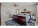Comfortable bedroom with a sleigh bed, accent rug, and natural lighting from multiple windows at 15122 Lake Ridge Rd, Charlotte, NC 28278