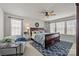 Inviting bedroom featuring a wooden sleigh bed, a ceiling fan, and natural light from multiple windows at 15122 Lake Ridge Rd, Charlotte, NC 28278