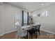 A well-lit dining area featuring a wooden table with seating and natural light from the windows at 15122 Lake Ridge Rd, Charlotte, NC 28278