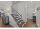 Welcoming entryway with hardwood floors, staircase with iron spindles, and a view of the front door at 15122 Lake Ridge Rd, Charlotte, NC 28278