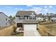 Exterior elevation showcasing a charming two-story home with stone accents, a well-manicured lawn, and a cozy front porch at 15122 Lake Ridge Rd, Charlotte, NC 28278