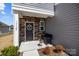 Charming home entrance with a stone accent wall and a cozy bench at 15122 Lake Ridge Rd, Charlotte, NC 28278
