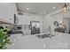 Modern kitchen features stainless steel appliances, white cabinetry, stone countertops, and stylish backsplash at 15122 Lake Ridge Rd, Charlotte, NC 28278