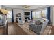 Cozy living room with a fireplace, hardwood floors, plenty of natural light and comfortable seating arrangement at 15122 Lake Ridge Rd, Charlotte, NC 28278
