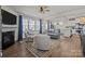 Bright and airy living room features hardwood floors, fireplace and windows, with an open view to the kitchen at 15122 Lake Ridge Rd, Charlotte, NC 28278