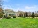 Expansive backyard with lush green grass, mature trees, and a patio area, perfect for outdoor entertaining at 1528 Ridge Haven Rd, Waxhaw, NC 28173