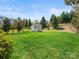 Large backyard featuring a storage shed, a well-maintained lawn, and mature trees for added privacy at 1528 Ridge Haven Rd, Waxhaw, NC 28173