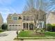 Charming two-story home with a manicured lawn, two-car garage, and stone accents on the facade at 1528 Ridge Haven Rd, Waxhaw, NC 28173