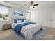 Cozy main bedroom featuring a tray ceiling, decorative molding, plush carpet, and a large window at 1528 Ridge Haven Rd, Waxhaw, NC 28173