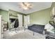 This green bedroom includes a ceiling fan, black bed frame, and carpet flooring at 1813 Robbins Meadows Dr, Waxhaw, NC 28173