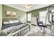 The green bedroom features a black bed, a rolling chair and desk, and carpet flooring at 1813 Robbins Meadows Dr, Waxhaw, NC 28173
