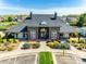 Community clubhouse featuring a stone facade, covered walkways, and landscaped front entrance at 1813 Robbins Meadows Dr, Waxhaw, NC 28173