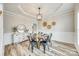 Dining room featuring wood floors, decorative trim, and a stylish chandelier at 1813 Robbins Meadows Dr, Waxhaw, NC 28173