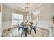 Bright dining area features wood floors, a table with seating for four, and great natural light at 1813 Robbins Meadows Dr, Waxhaw, NC 28173