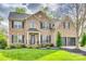 Stunning brick home with a lush green lawn, manicured landscaping, and a two-car garage at 1813 Robbins Meadows Dr, Waxhaw, NC 28173
