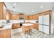 Well-lit kitchen with stainless steel appliances, an island with bar stools, and wood-look flooring at 1813 Robbins Meadows Dr, Waxhaw, NC 28173
