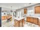 Bright kitchen with white countertops, a central island, and a view of the adjacent living area at 1813 Robbins Meadows Dr, Waxhaw, NC 28173