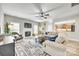 Cozy living room featuring a fireplace, ceiling fan, and an open view to the kitchen at 1813 Robbins Meadows Dr, Waxhaw, NC 28173