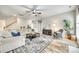 Spacious living room with wood floors, large sectional sofa, and plenty of natural light at 1813 Robbins Meadows Dr, Waxhaw, NC 28173