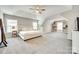 Spacious main bedroom with neutral tones, carpet, and natural light from large windows at 1813 Robbins Meadows Dr, Waxhaw, NC 28173