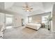 Main bedroom with tray ceilings, ensuite access, and large windows that offer plenty of natural light at 1813 Robbins Meadows Dr, Waxhaw, NC 28173