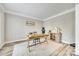 Bright home office features wood floors, a desk, chair and ample natural light at 1813 Robbins Meadows Dr, Waxhaw, NC 28173