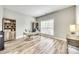 Home office featuring light gray walls, wood floors, and ample natural light from a large window at 1813 Robbins Meadows Dr, Waxhaw, NC 28173