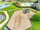 Community playground with play equipment, a basketball court and a swimming pool in the background at 1813 Robbins Meadows Dr, Waxhaw, NC 28173