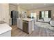 Modern kitchen featuring stainless steel appliances, a center island, and hardwood floors at 1940 Old Rivers Rd, Concord, NC 28027