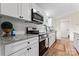 Bright kitchen features white cabinets, subway tile backsplash, granite countertops, and stainless steel appliances at 205 Jim Patterson Rd, Kings Mountain, NC 28086