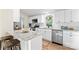 Open kitchen with white cabinetry, granite countertops, stainless steel appliances, and eat-in island at 205 Jim Patterson Rd, Kings Mountain, NC 28086