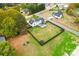 Aerial view of fenced backyard and lovely white and black home with trees at 211 Killian Rd, Stanley, NC 28164