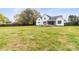Expansive backyard featuring a patio with a stone fireplace and plenty of green space at 211 Killian Rd, Stanley, NC 28164