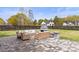 Large backyard features a stone patio with an outdoor fireplace and manicured lawn at 211 Killian Rd, Stanley, NC 28164