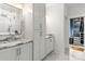 Bathroom with double vanity, gray tile floors, and adjacent walk-in closet at 211 Killian Rd, Stanley, NC 28164