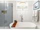 Spa-like bathroom featuring a standalone tub with shower at 211 Killian Rd, Stanley, NC 28164