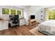 Bright bedroom with a built-in desk, hardwood floors, and a cozy sitting area at 211 Killian Rd, Stanley, NC 28164