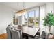 Bright dining room features a large window, chandelier, and seating for six at 211 Killian Rd, Stanley, NC 28164