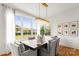 Bright dining room features a large window, chandelier, and seating for six at 211 Killian Rd, Stanley, NC 28164