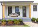 Inviting front porch with bench seating and gray painted stairs and lovely landscaping at 211 Killian Rd, Stanley, NC 28164