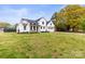 Beautiful modern farmhouse exterior with a well-maintained lawn and landscaping at 211 Killian Rd, Stanley, NC 28164