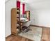 Well-lit home office with built-in shelves, desk, and natural hardwood floors at 211 Killian Rd, Stanley, NC 28164