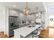 Modern kitchen featuring gray cabinets, a large center island, and stainless steel appliances at 211 Killian Rd, Stanley, NC 28164