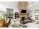 Comfortable living room features a stone fireplace, large windows, and stylish furnishings at 211 Killian Rd, Stanley, NC 28164
