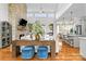 Spacious living room with stone fireplace, hardwood floors, and a view into the kitchen at 211 Killian Rd, Stanley, NC 28164