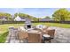 Stone patio with an outdoor fireplace and comfortable seating for entertaining at 211 Killian Rd, Stanley, NC 28164
