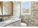 Stylish powder room featuring patterned wallpaper, marble countertop, and gold fixtures at 211 Killian Rd, Stanley, NC 28164