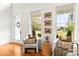Bright sitting area featuring two armchairs, hardwood flooring, and natural light from picture windows at 211 Killian Rd, Stanley, NC 28164